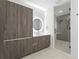 Modern bathroom with a walk-in shower and sleek wood cabinets at 777 3Rd N Ave # 1204, St Petersburg, FL 33701