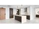 Modern kitchen with island, stainless steel appliances, and dark wood cabinetry at 777 3Rd N Ave # 1204, St Petersburg, FL 33701