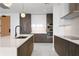 Modern kitchen with island, stainless steel appliances, and dark wood cabinetry at 777 3Rd N Ave # 1204, St Petersburg, FL 33701