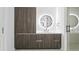 Modern bathroom with wood cabinets and a large mirror at 777 3Rd N Ave # 1204, St Petersburg, FL 33701