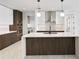 Modern kitchen with island, stainless steel appliances, and dark wood cabinetry at 777 3Rd N Ave # 1204, St Petersburg, FL 33701