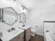 Bathroom boasts double sinks, hexagon mirrors, and a large soaking tub at 2193 Peake St, North Port, FL 34286