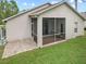 Spacious screened porch with paver patio and grassy yard at 2193 Peake St, North Port, FL 34286