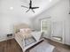 Main bedroom with plush bed, wood floors, and large mirror at 2193 Peake St, North Port, FL 34286