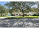 Attractive home with mature shade trees in front yard and long driveway at 12912 Willoughby Ln, Hudson, FL 34667