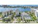 Aerial view showing condo building, parking, tennis courts, and waterfront at 660 Island Way # 401, Clearwater, FL 33767