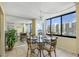 Bright dining area featuring elegant chandelier and big windows with beautiful water views at 660 Island Way # 401, Clearwater, FL 33767