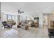 Bright living room features floor-to-ceiling windows, tile floors, and comfortable seating at 660 Island Way # 401, Clearwater, FL 33767