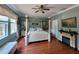 Bright bedroom featuring a post bed, ceiling fan, and fireplace at 7607 55Th E St, Ellenton, FL 34222