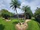 Screened pool area with patio furniture and lush tropical landscaping at 7607 55Th E St, Ellenton, FL 34222
