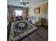 Living room with sectional sofa, large area rug, and hardwood floors at 7607 55Th E St, Ellenton, FL 34222