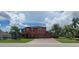 Two-story house exterior with brick paver driveway and lush landscaping at 7607 55Th E St, Ellenton, FL 34222