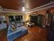 Relaxing living room featuring a sectional sofa and hardwood flooring at 7607 55Th E St, Ellenton, FL 34222