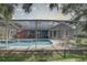 Screened pool area with lounge chairs and patio furniture at 4541 Whitetail Ln, New Port Richey, FL 34653