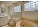 Bathroom with double sinks, shower, and large garden tub at 12408 Seabrook Dr, Tampa, FL 33626