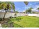 Open grassy backyard with fence and plants at 12408 Seabrook Dr, Tampa, FL 33626