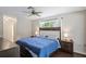 Bedroom with large bed and wood dresser with ample storage at 12912 Willoughby Ln, Hudson, FL 34667