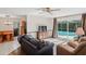 Living room with pool view, comfy seating, and hardwood floors at 12912 Willoughby Ln, Hudson, FL 34667