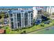Aerial view of waterfront high rise building with ocean and city views at 9415 Blind Pass Rd # 803, St Pete Beach, FL 33706