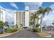 High rise building exterior with ample parking and landscaping at 9415 Blind Pass Rd # 803, St Pete Beach, FL 33706
