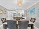 Elegant dining room with marble-top table and six black leather chairs at 9415 Blind Pass Rd # 803, St Pete Beach, FL 33706