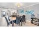Dining area with a marble top table and six black leather chairs at 9415 Blind Pass Rd # 803, St Pete Beach, FL 33706