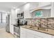 Modern kitchen with stainless steel appliances and granite countertops at 9415 Blind Pass Rd # 803, St Pete Beach, FL 33706