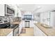Modern kitchen with stainless steel appliances and granite countertops at 9415 Blind Pass Rd # 803, St Pete Beach, FL 33706