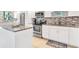 Modern kitchen with granite countertops and updated cabinetry at 9415 Blind Pass Rd # 803, St Pete Beach, FL 33706