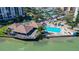 Aerial view of community pool, clubhouse, and marina at 9415 Blind Pass Rd # 803, St Pete Beach, FL 33706