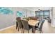 Bright dining room with a marble-top table and six black leather chairs at 9415 Blind Pass Rd # 803, St Pete Beach, FL 33706