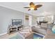 Spacious living room with sectional sofa and large TV, offering city views at 9415 Blind Pass Rd # 803, St Pete Beach, FL 33706