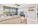 Bright living room featuring a sectional sofa and access to a balcony at 9415 Blind Pass Rd # 803, St Pete Beach, FL 33706