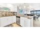 Open concept kitchen with granite countertops and island at 9415 Blind Pass Rd # 803, St Pete Beach, FL 33706