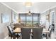 Dining area with marble-top table and six leather chairs, overlooking cityscape at 9415 Blind Pass Rd # 803, St Pete Beach, FL 33706