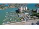 Aerial view showing marina, tennis courts, and building at 9415 Blind Pass Rd # 803, St Pete Beach, FL 33706