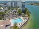 Community pool and patio area with water view at 9415 Blind Pass Rd # 803, St Pete Beach, FL 33706