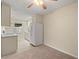 Kitchen features white appliances and light wood cabinets at 3247 38Th S Way # C, St Petersburg, FL 33711