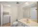 Bathroom features vanity, toilet, and adjacent laundry area at 3247 38Th S Way # C, St Petersburg, FL 33711