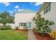 Charming condo building with a teal door and landscaping at 3247 38Th S Way # C, St Petersburg, FL 33711