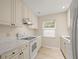 Galley kitchen with white appliances and marble countertops at 3247 38Th S Way # C, St Petersburg, FL 33711