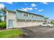 Condo building with multiple garages and a car parked in front at 3247 38Th S Way # C, St Petersburg, FL 33711