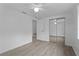 Bedroom with wood-look floors, window, and mirrored closet at 651 Jungle Queen Way, Longboat Key, FL 34228