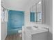 Clean bathroom with light blue shower/tub combo and white vanity at 651 Jungle Queen Way, Longboat Key, FL 34228