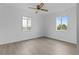 Bright bedroom with vinyl flooring, dual pane windows, and ceiling fan at 651 Jungle Queen Way, Longboat Key, FL 34228