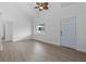 Living room with vaulted ceiling, light flooring, and white walls at 651 Jungle Queen Way, Longboat Key, FL 34228