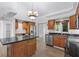 Kitchen features island, wood cabinets, granite countertops and stainless steel appliances at 651 Jungle Queen Way, Longboat Key, FL 34228