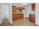 Simple kitchen with wood cabinets and tile flooring at 651 Jungle Queen Way, Longboat Key, FL 34228