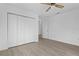 Spacious bedroom with light gray vinyl flooring, ceiling fan, and large closet at 651 Jungle Queen Way, Longboat Key, FL 34228