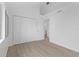 Bedroom with wood-look floors and large closet at 651 Jungle Queen Way, Longboat Key, FL 34228